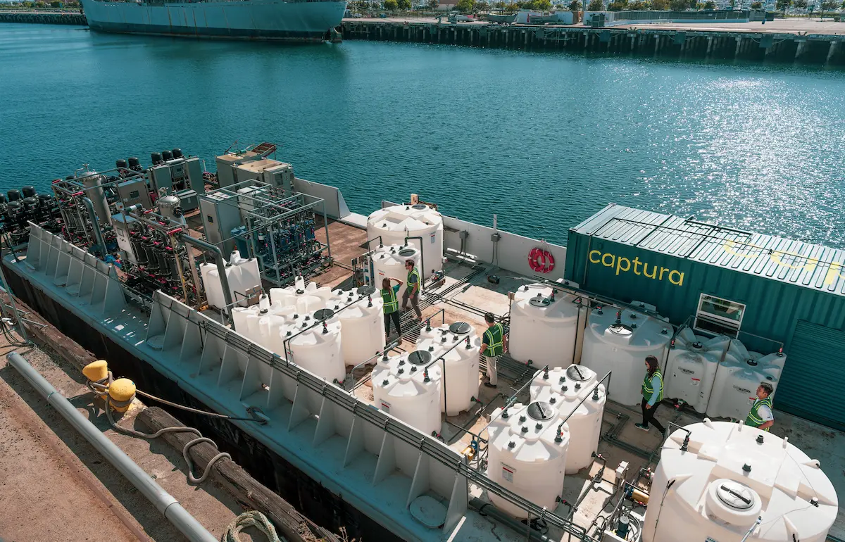 Captura workers walk on a barge equipped with Captura's carbon capture technology.