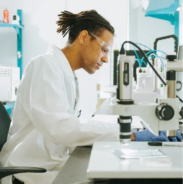 Lab worker at a microscope