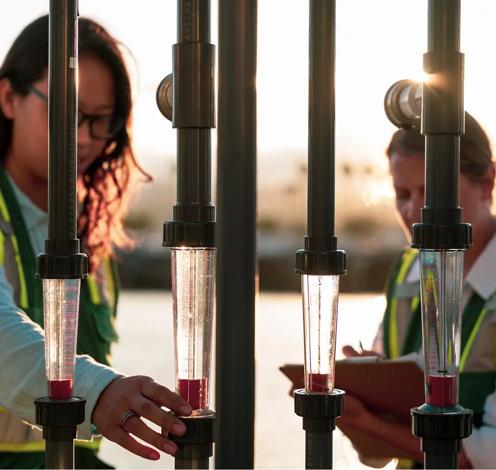 Two team members work on site